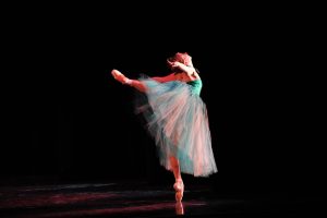 Megan Jacobs balances in "Emeralds." The George Balanchine Trust. 