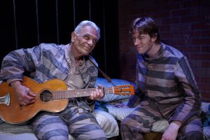Ike (Robert Grossman, left) and Tommy (Benjamin Cole) are generations apart except for one thing.