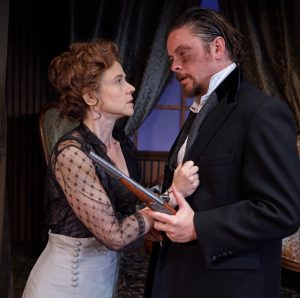 Hedda (Mhari Sandoval)  may as well pull the trigger herself as she exhorts Eilert Lovborg (Richard Baird) to pay an ultimate price.
