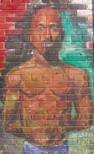 This likeness of the late Tupac Shakur colors an exterior in New York City's East Harlem, Shakur's birthplace. Image by JJ & Special K.