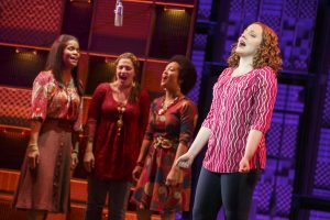 Carole King (Abby Mueller, right) lights up one of her many girl-group clients en route to her legendary place in music. Photo by Joan Marcus.